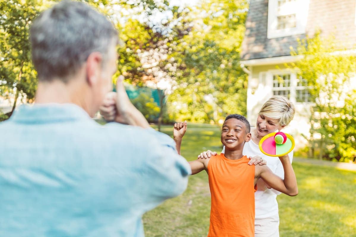A family playing catch in the backyard