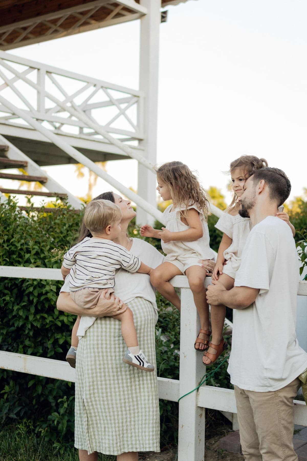 A family laughing together on their porch steps