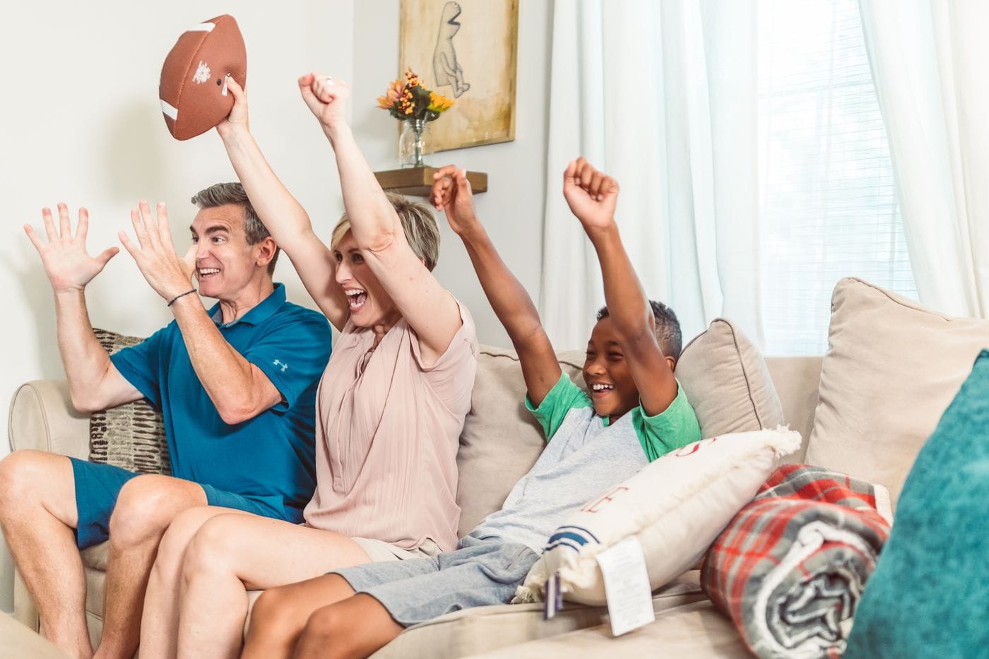 A family celebrating together on the couch