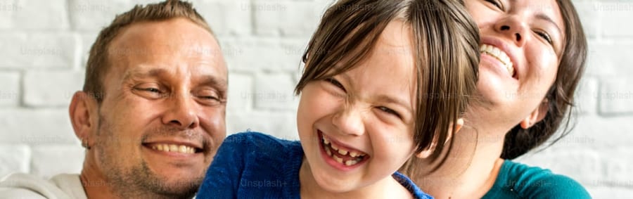 A young family covered through CoverageCo, laughing together